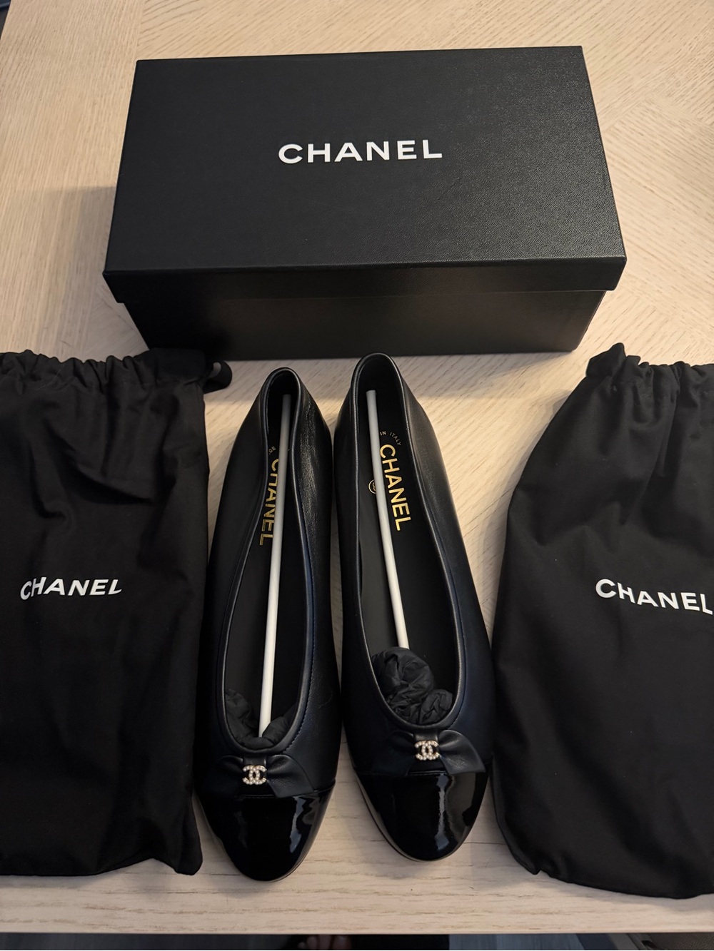 CHANEL Black Leather Cap-Toe Ballet Flats with Patent Toe and CC Charm